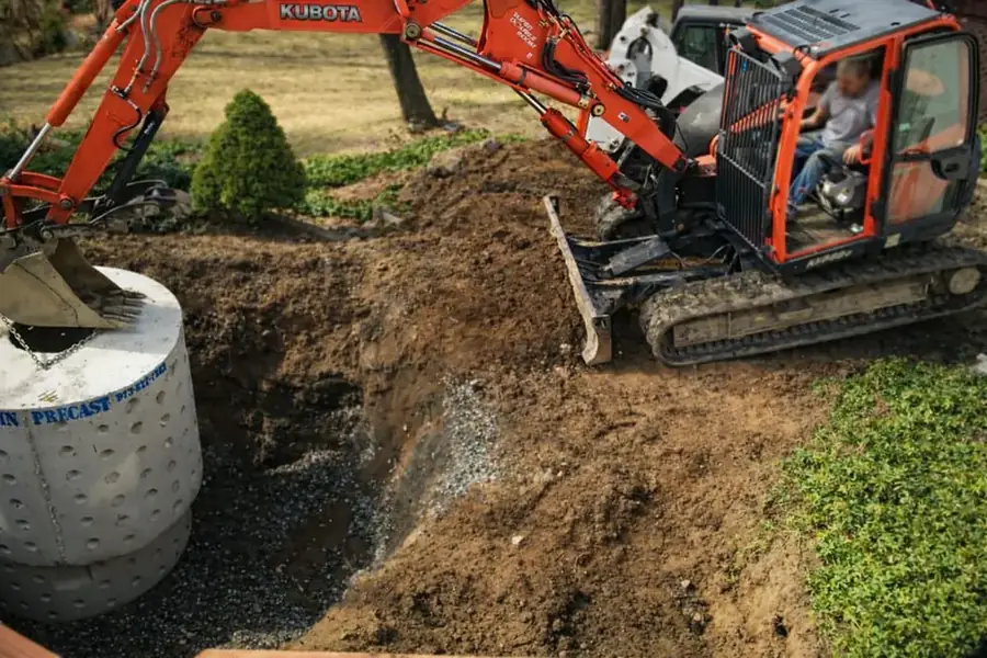 Compact excavator placing a precast structure